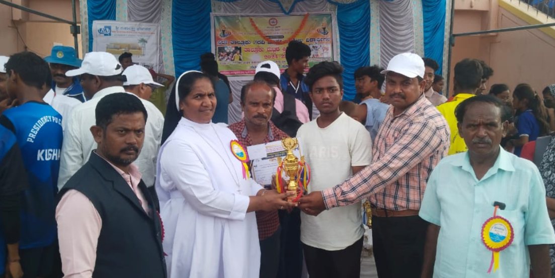 St. Anne's student receiving a sports trophy